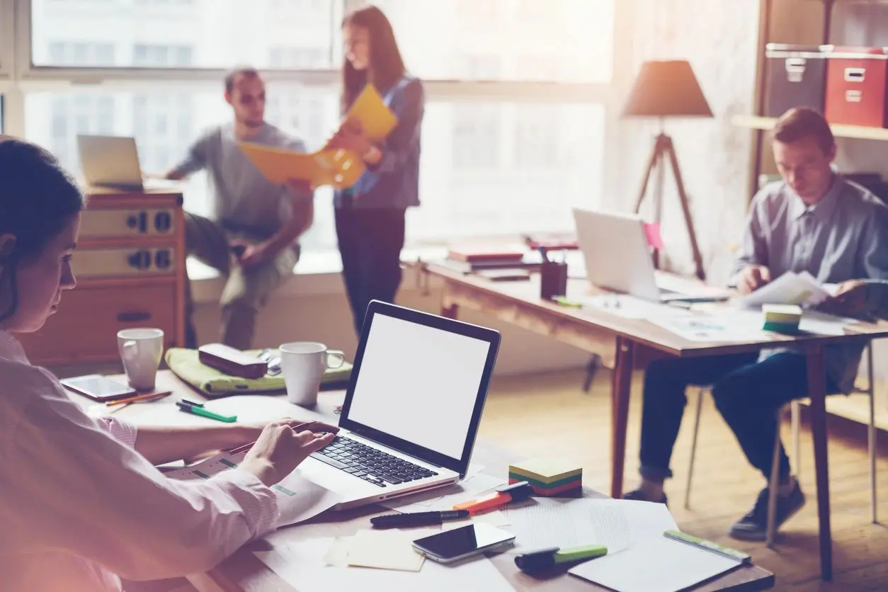 A group of people in an office setting.